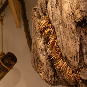 This installation is a sequel to my driftwood series. I see it as a continuation of life, by anthropomorphizing the surface of driftwood and covering it with paper cut fuzz. They  also suspended in the space with red ambient lighting and the background sound of  chainsaws cutting through the wood.