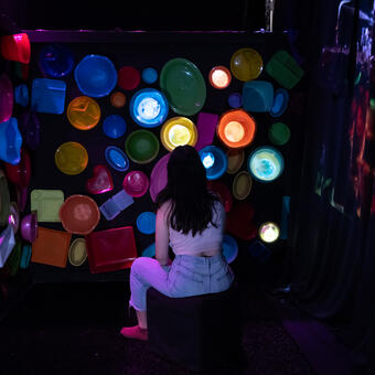 Person sitting in video projection installation