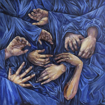 Hands intermingling in a sea of blue fabric