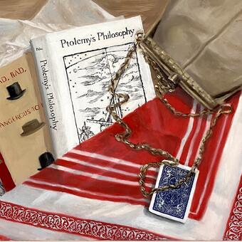 Laying flat on a table is tissue paper, two book covers, two playing cards, a purse and a bandana. 