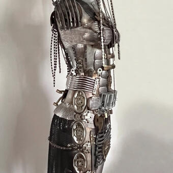 Warrior Angel figure armored ironically in stereotypical domestic "home & hearth" found objects. 