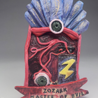 An eyeball hooked up to a battery with the text "Zozark Master of Evil" beneath