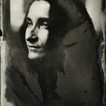 A wet plate collodion portrait of a woman with black hair in 3-quarter view