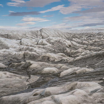 landscape of heavily crevassed ice laced with meltwater streams