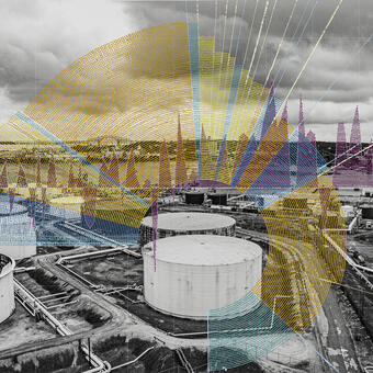 A landscape photograph showing Large oil storage tanks with a brightly painted graph made of dots on top.