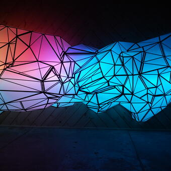 Buisine (2024) by the artist Stephen Hendee, Corrugated polypropylene, tape, glue, programmable LED system 24'x 7'x4'