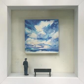 Museum guard, next to bench, staring at beach sky painting.