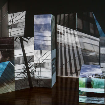 A dark room showing multiple projections.