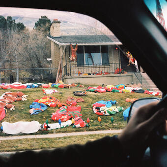 Photo of christmas decorations deflated on a lawn.