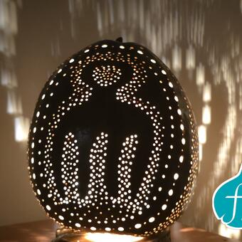The design for the Duafe Gourd lamp  features a prominent ‘fro comb’ symbol on the front, which is the symbol for beauty in the Akan Adinikra Symbol world.