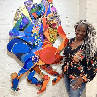 Soul Boogie is a multilayered wood collage showing two colorful full bodied figures dancing together with hands clasped together