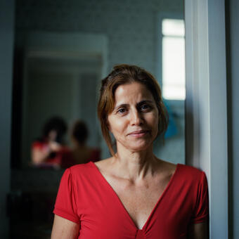 A self/portrait. My mother poses in front of her bathroom on a rainy day. 