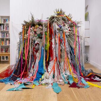 Mother and Child Dimensions Vary Acrylic on canvas, leather from my Grandfather’s couch, styrofoam, beads, cowrie shells, bells, medicine bottles, seeds 2025