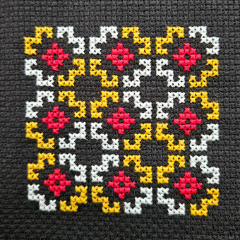 Black background with gold, white, and red flowers.