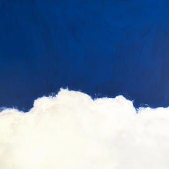 Close up of the top of a white cloud against a blue sky