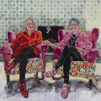 two elderly women sitting in colorful chairs looking out at the viewer