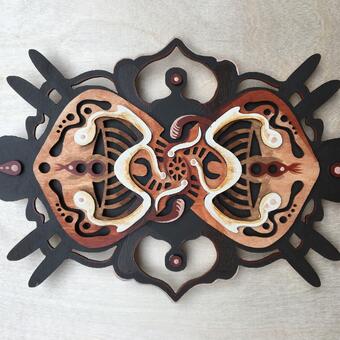 A red, brown, and tan wooden sculpture