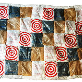 Checkered blanket made of plastic bags of various repeating designs