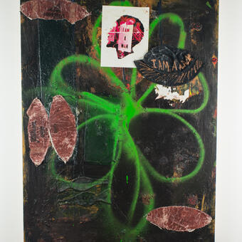 abstract painting with spray painted flower in middle (green), football skin and paper 