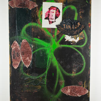 abstract painting with spray painted flower in middle (green), football skin and paper 