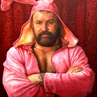 A handsome bearded man wearing a floppy pink rabbit costume