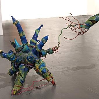 Estrella the Crone, 2022 Sculpture 3.5 ft tall x 6 ft wide x 2 ft deep, ceramic, welded steel and acrylic This is a ball with starfish- like or octopus - like arms all around it . one of its arms has jettisoned from its body . Thin steel loops are like blood vessels still attached to the arm and the body. The work is in shades of teal, blues and greens with highlights in hot pink and gold.
