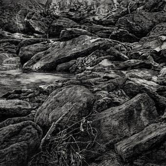 Realistic charcoal drawing of large rocks in a streambed