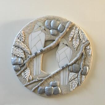 bas relief concrete sculpture, white stained glass birds, silver cherries