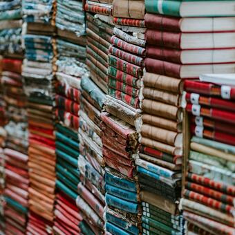 Books neatly stacked with spines horizontal