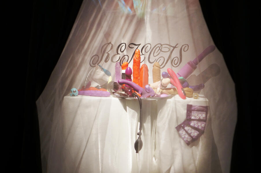 an altar covered in rejected sex toys with the word " rejects" written above it. 