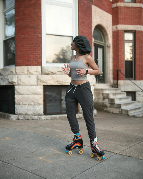 A young woman on roller skates on Reservoir Street.