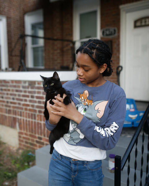 A young girl and her cat on Callow Ave