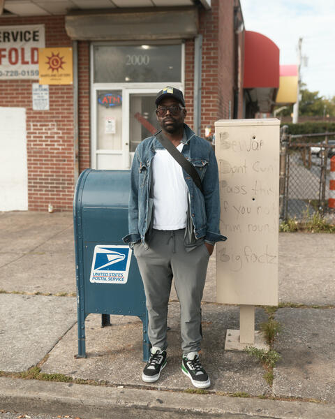 A man posing by the former laundromat at Linden and North Ave