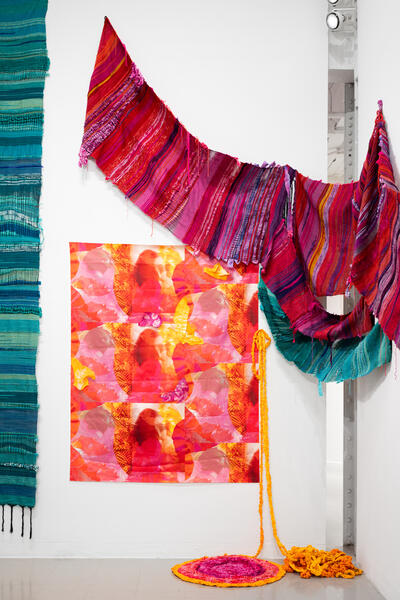 installation of three colorful weavings