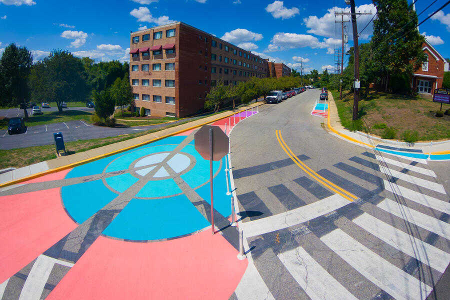 Rays of Peace, birds eye view of traffic calming pavement art peace sign and crosswalk