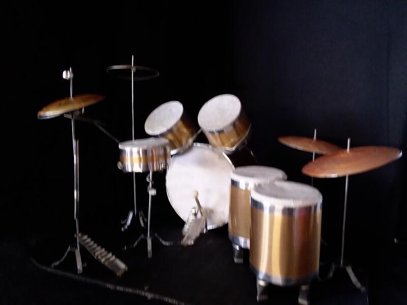 View 2: Miniature drum set for marionette drummer, Reptilian Rockstar, showing rear view with pedals. mixed media 2025