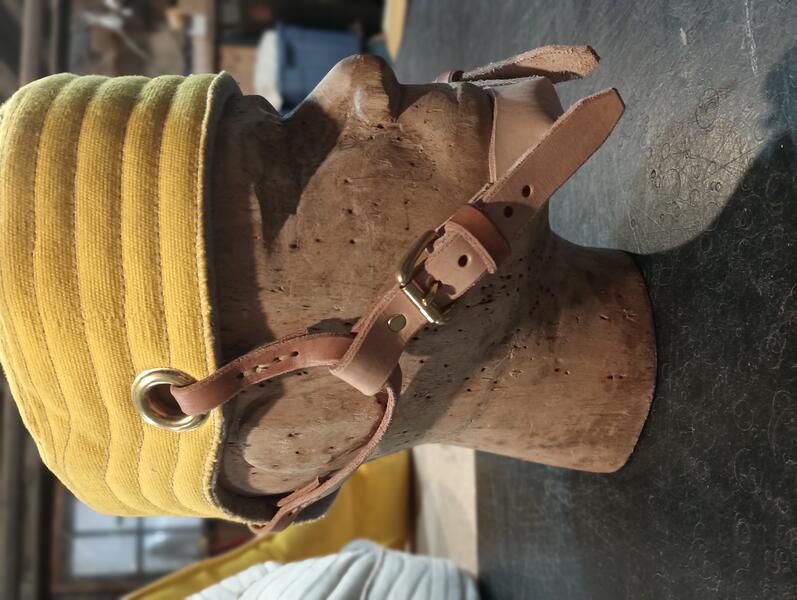 yellow padded hat with chin strap