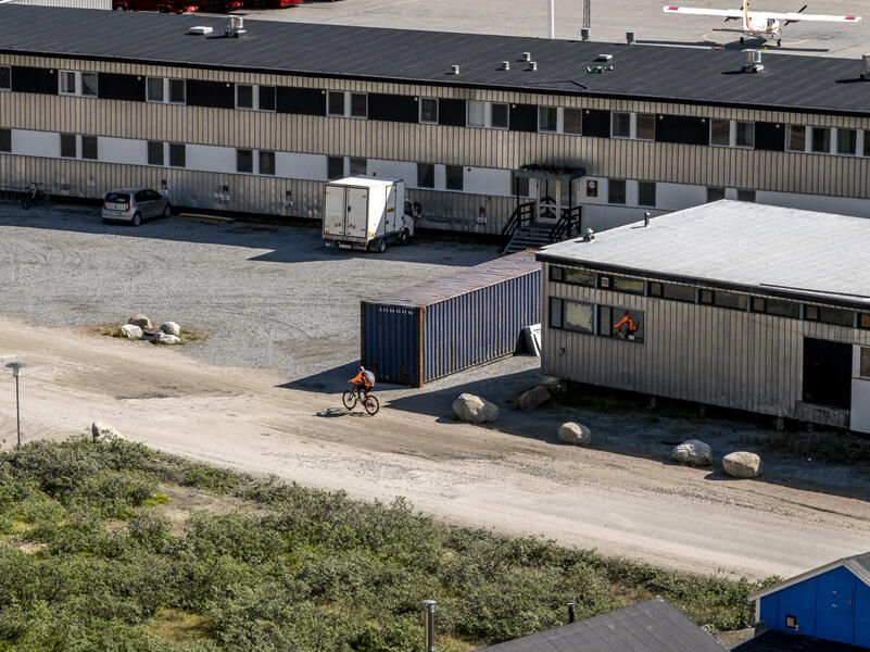 Cyclist Passing Airport Terminal (2022)