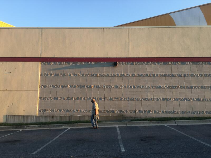A parking lot at Mondawmin Mall right as the sun sets