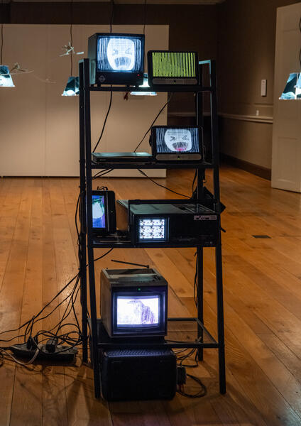 Detail shot of a reclaimed metal shelf used in the installation with the found and salvaged/repaired televisions