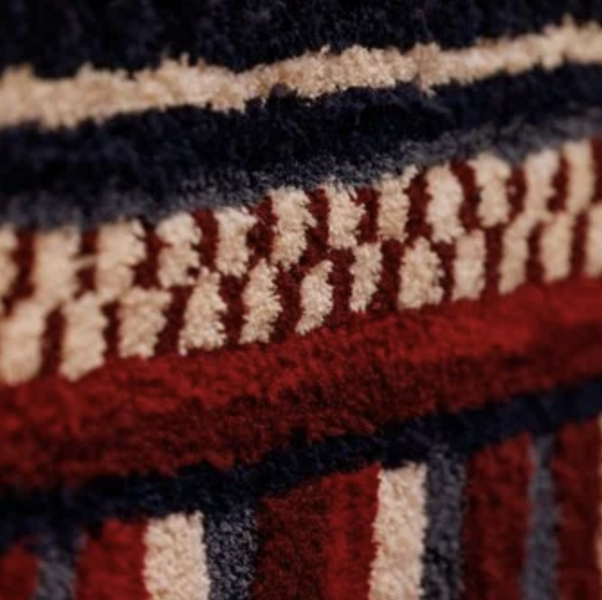 Detail, hand tufted rug, how stunningly beautiful that our sacred respect for earth, for life is deeper than our rage (Portrait of Salua Moussawel)