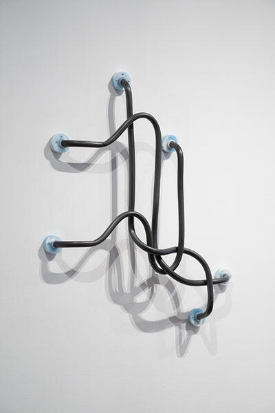 Speculative Grab Bar #3: Triad, 2023. PVC pipe, silicon, graphite, hardware. 30” x 24” x 3”