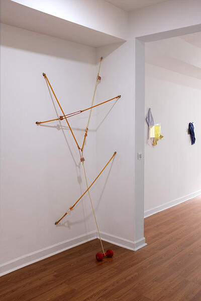 Locked stretch, 2025. latex tubing, silicone, hardware, dumbbell 90”x 40”x 8”