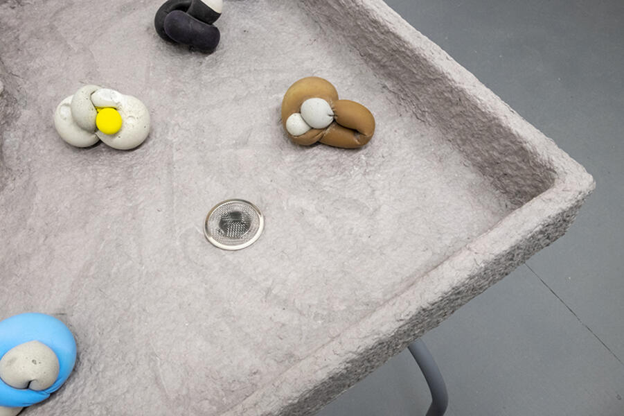 Play Party, 2018. Wood, concrete, latex, paper pulp, table legs.  35” x 24” x 30” 