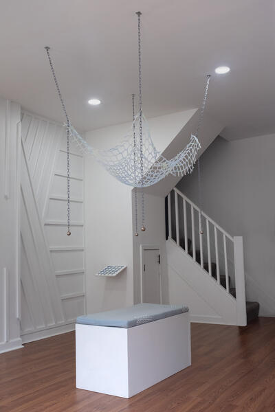 Sick Play: Body of a Trap, 2025. Chain, hardware, metal weights, silicone, 64”x42”x30”