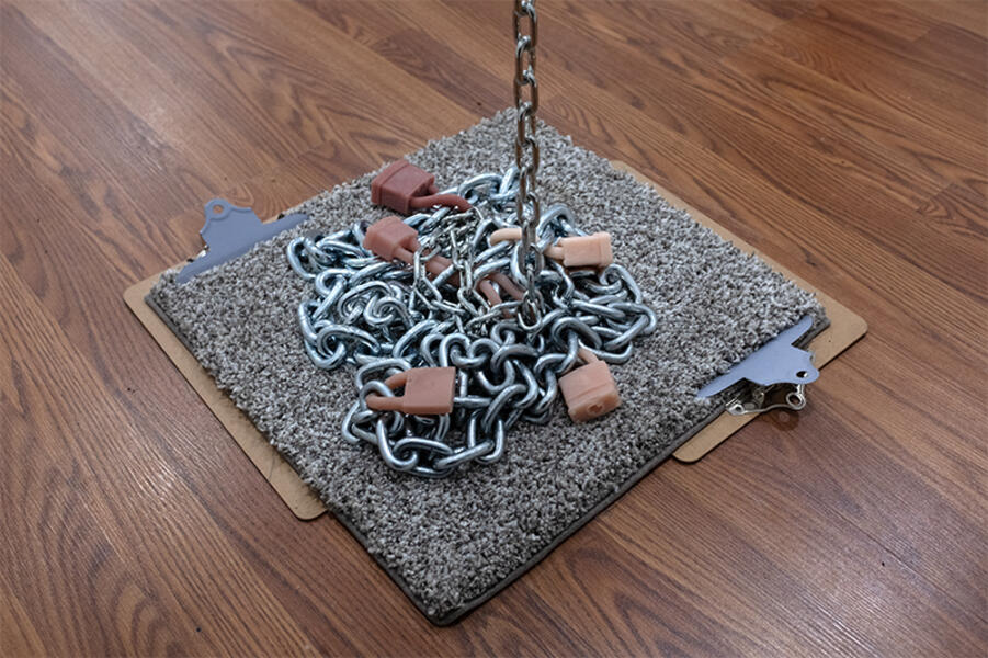Chainlinked, (detail) 2025. Silicone, metal chain, carpet, spray paint, clipboards  16” x 16” x 168”
