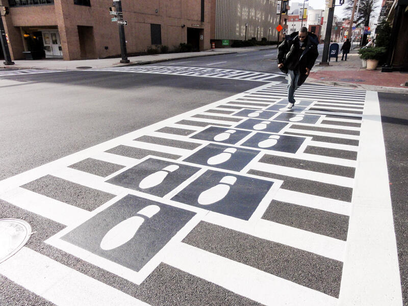 Hopscotch Crosswalk Colossus - business man jumping shoe prints