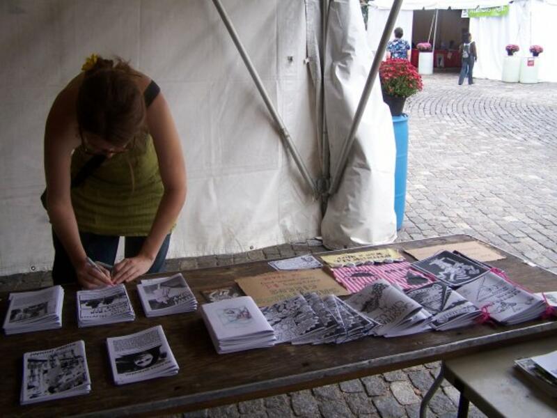 folding a zine while tabling at the zine pavalion @ Baltimore Bookfair
