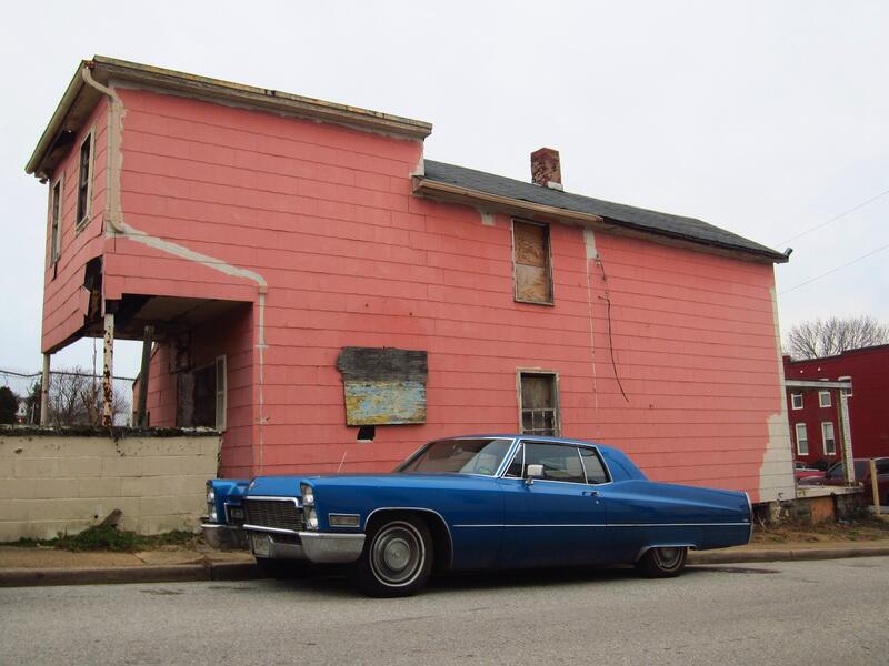 blue caddy by the pink house