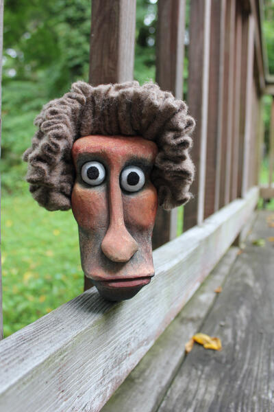 Carved and painted wooden head.